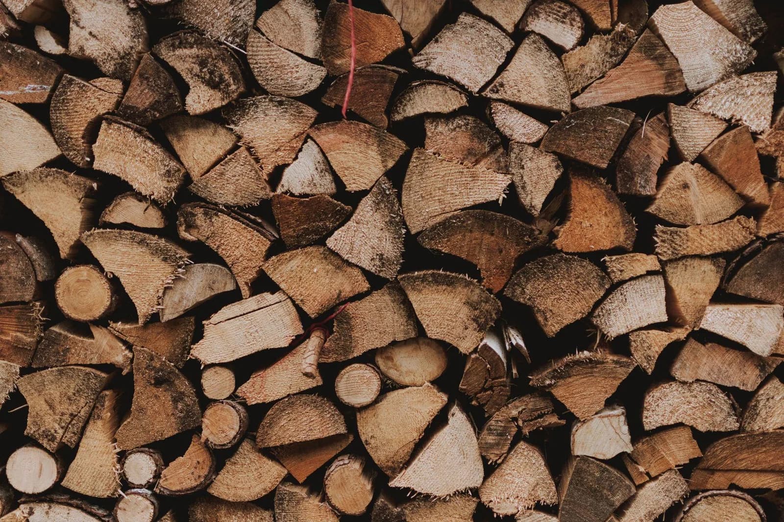 A close view of split firewood stacked with the cut ends facing outward.