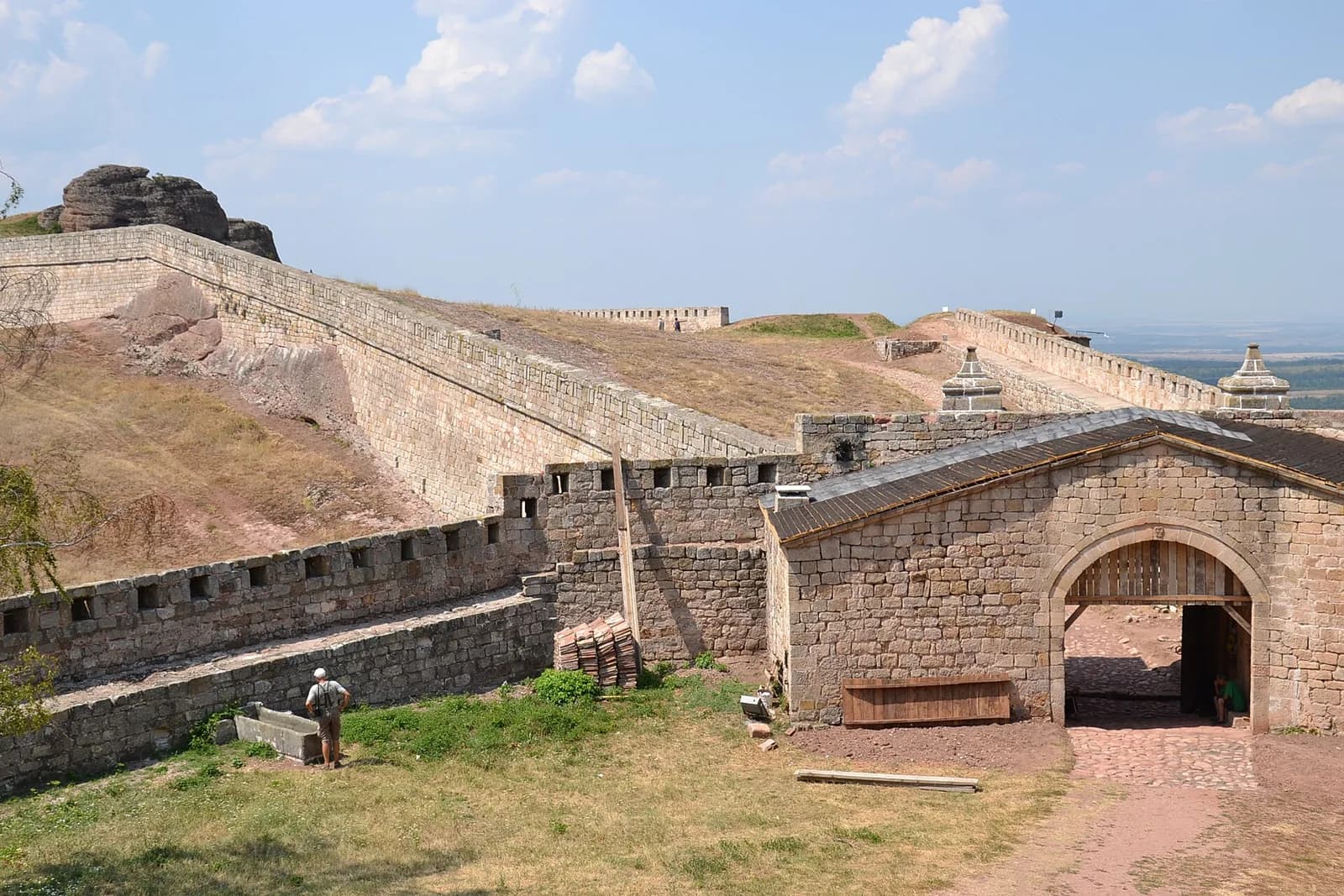Stone gateway and walls of Belogradchik Fortress below the rocks