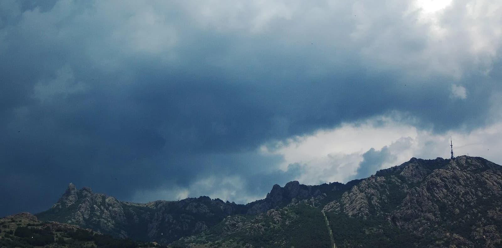 A rocky ridge at Karandila beneath heavy clouds.
