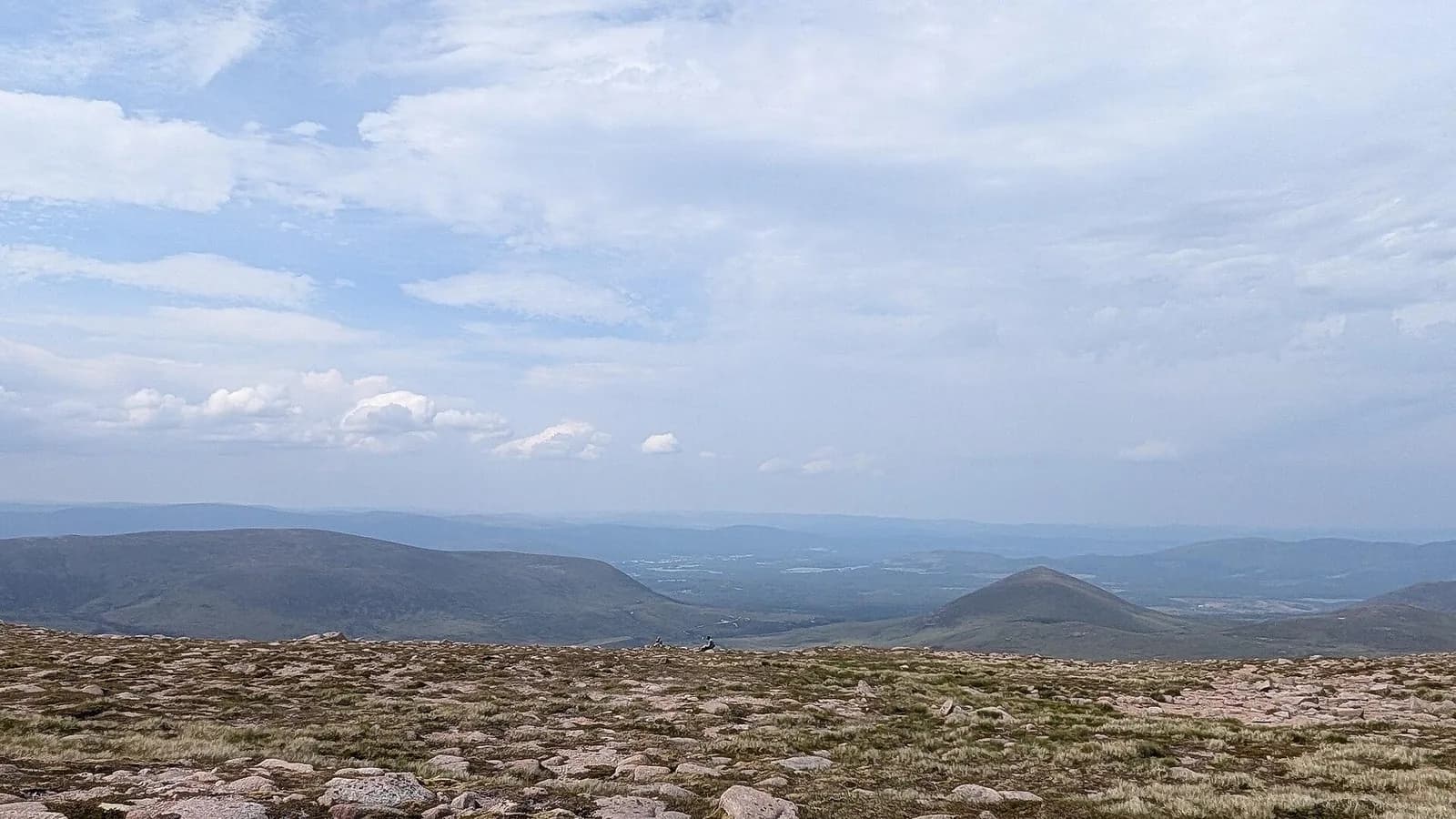 Open stony uplands with distant rounded hills in the Cairngorms.