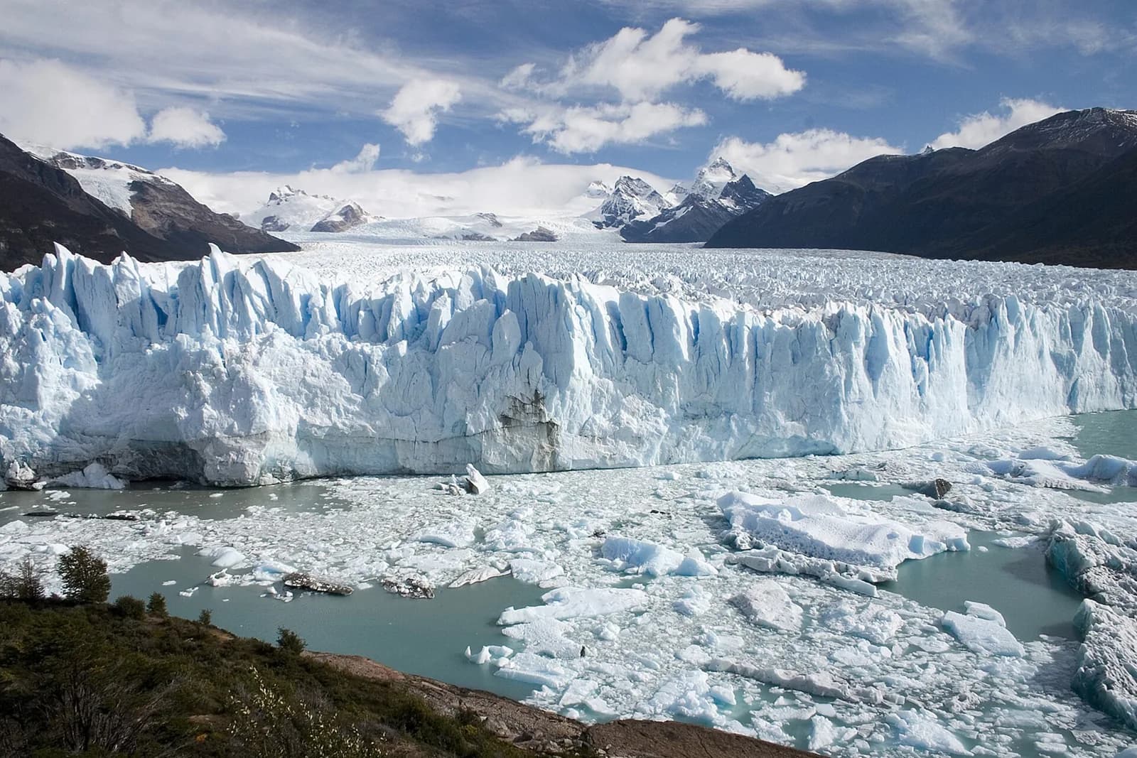 The fractured ice front of Perito Moreno Glacier beside the lake